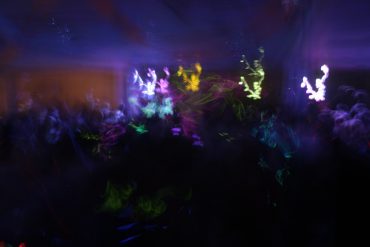 Dark party scene with blurry lights and people