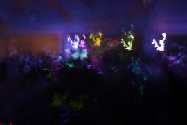 Dark party scene with blurry lights and people